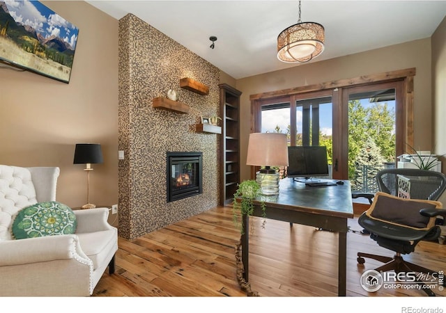 5709 Old Legacy Dr, Fort Collins, CO 80528 - office area with built in features, wood finished floors, and a premium fireplace