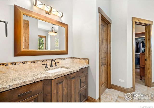 5709 Old Legacy Dr, Fort Collins, CO 80528 - bathroom with vanity and a walk in closet