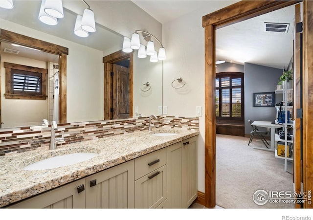 5709 Old Legacy Dr, Fort Collins, CO 80528 - bathroom with tasteful backsplash, double vanity, and vaulted ceiling