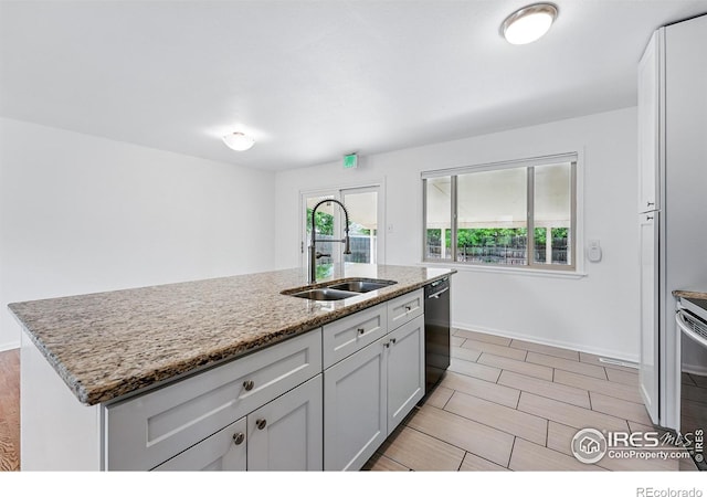 4462 Hamilton Ct, Boulder, CO 80305 - kitchen featuring a sink, dishwashing machine, white cabinets, light stone counters, and baseboards