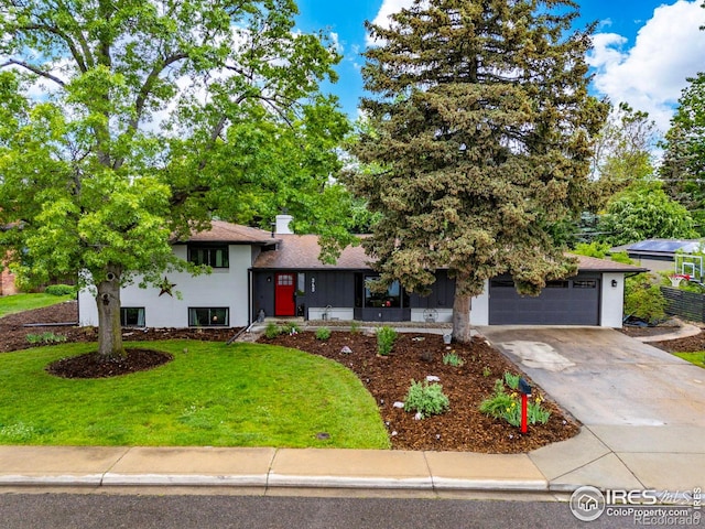 365 Mohawk Dr, Boulder, CO 80303 - tri-level home featuring concrete driveway, an attached garage, a front yard, and roof with shingles