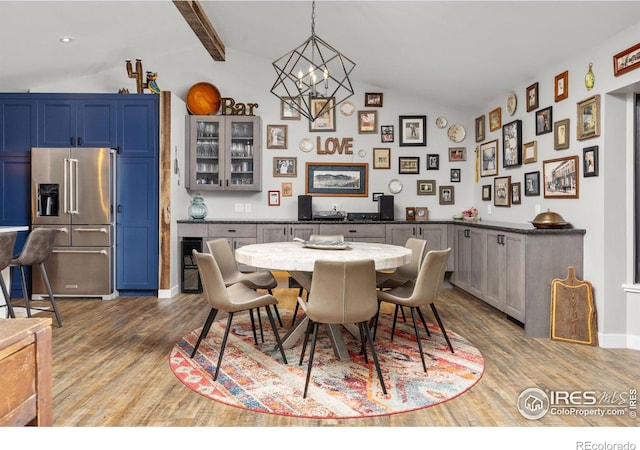 365 Mohawk Dr, Boulder, CO 80303 - dining area with lofted ceiling, wood finished floors, baseboards, and a chandelier