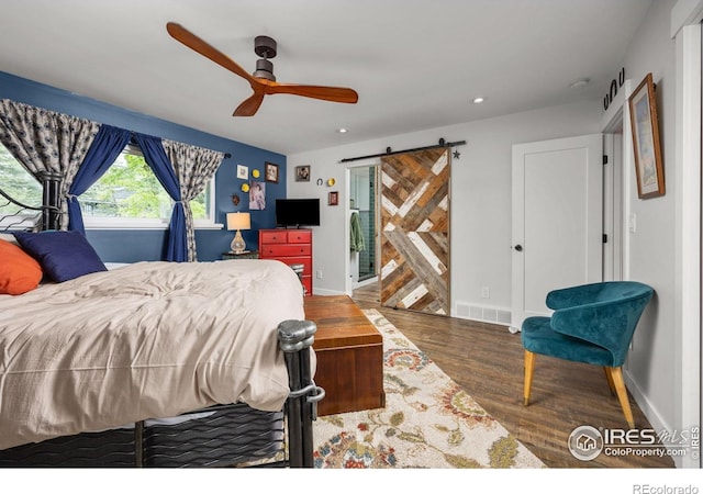 365 Mohawk Dr, Boulder, CO 80303 - bedroom with a barn door, wood finished floors, recessed lighting, ceiling fan, and baseboards