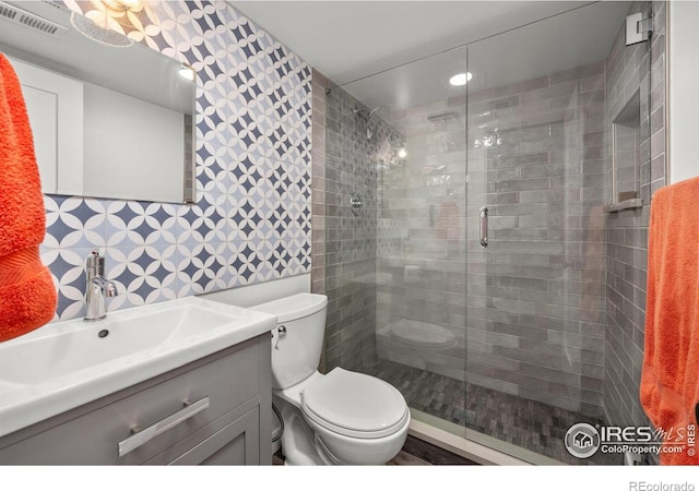 365 Mohawk Dr, Boulder, CO 80303 - full bathroom with vanity, toilet, a shower stall, and wallpapered walls