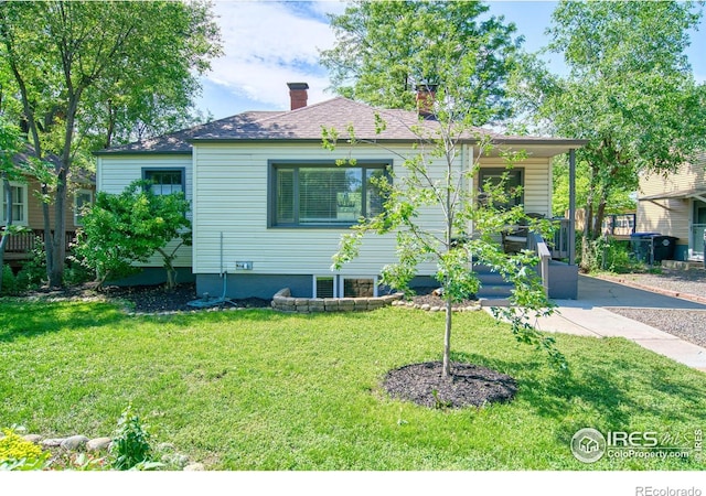 1233 Carolina Ave, Longmont, CO 80501 - bungalow-style home featuring a front lawn and a chimney
