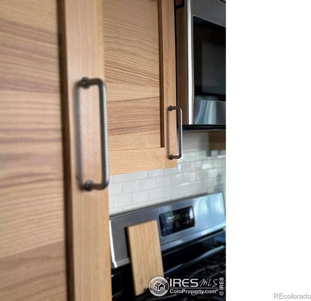 1233 Carolina Ave, Longmont, CO 80501 - kitchen featuring tasteful backsplash, stainless steel microwave, and wall oven