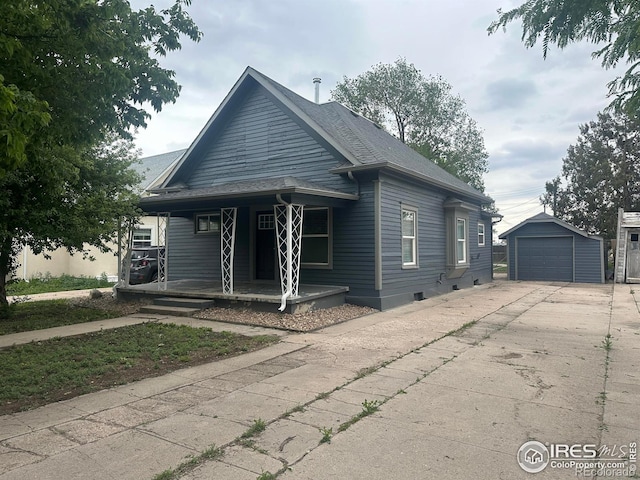 522 N 4th St, Sterling, CO 80751 - view of front of property with a porch, driveway, a garage, an outdoor structure, and a shingled roof