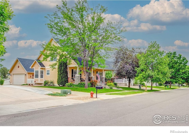 1421 Canal Dr, Windsor, CO 80550 - view of front of property with a garage, concrete driveway, covered porch, and a front yard