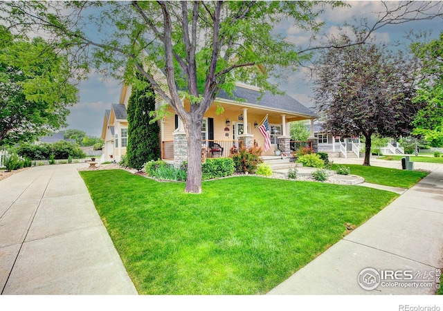 1421 Canal Dr, Windsor, CO 80550 - view of front facade featuring covered porch, a front yard, and driveway