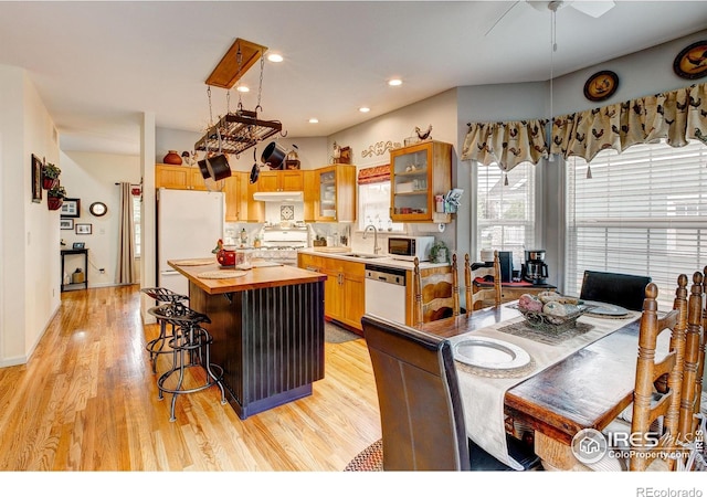 1421 Canal Dr, Windsor, CO 80550 - kitchen featuring white appliances, a sink, wood counters, a center island, and light wood-type flooring