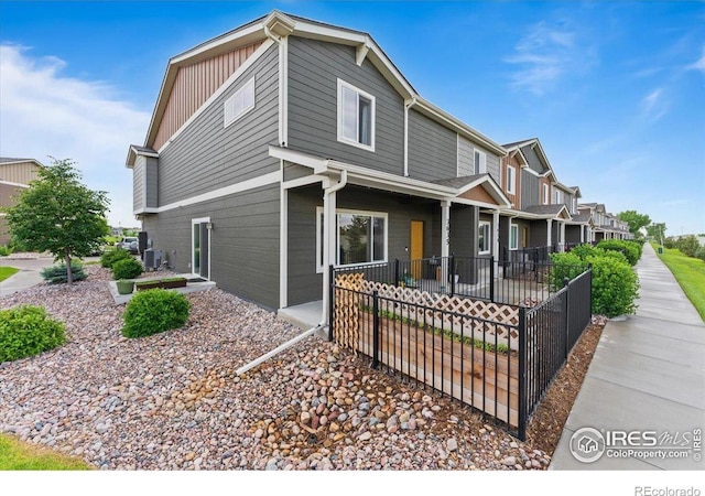 3635 Ronald Reagan Ave, Wellington, CO 80549 - view of front of house with central air condition unit, covered porch, and board and batten siding