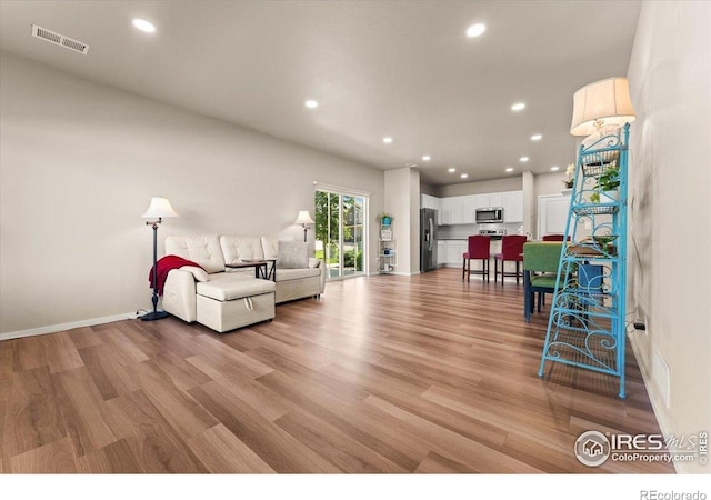 3635 Ronald Reagan Ave, Wellington, CO 80549 - living area featuring light wood-style flooring, recessed lighting, and baseboards