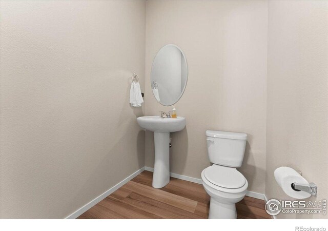 3635 Ronald Reagan Ave, Wellington, CO 80549 - bathroom with toilet, wood finished floors, and baseboards