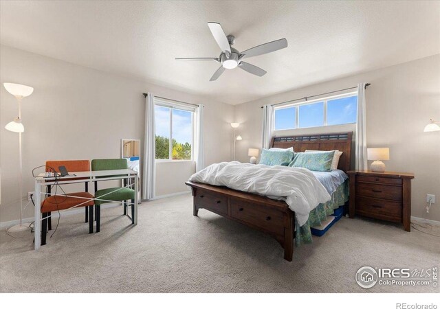 3635 Ronald Reagan Ave, Wellington, CO 80549 - bedroom with multiple windows, carpet floors, baseboards, and ceiling fan