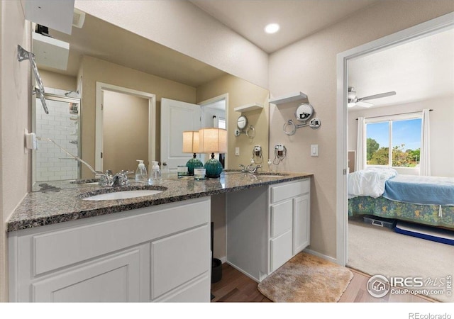 3635 Ronald Reagan Ave, Wellington, CO 80549 - ensuite bathroom with double vanity, wood finished floors, and a ceiling fan
