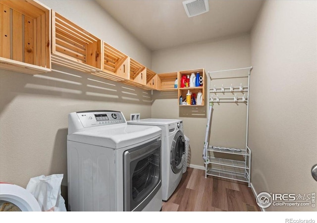 3635 Ronald Reagan Ave, Wellington, CO 80549 - laundry area featuring independent washer and dryer, wood finished floors, and baseboards