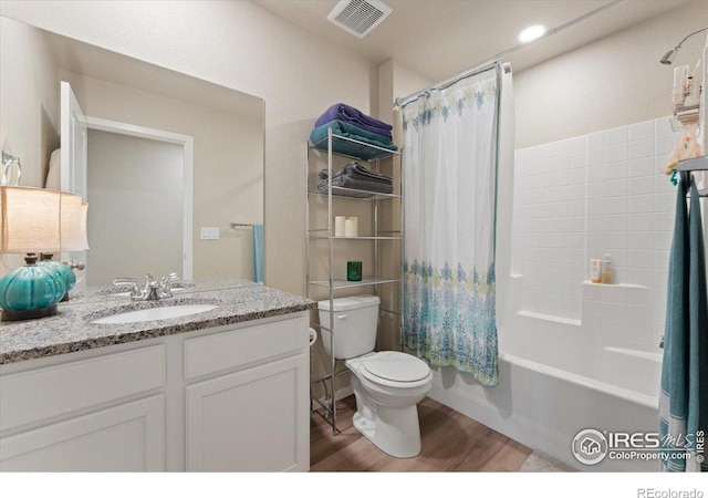 3635 Ronald Reagan Ave, Wellington, CO 80549 - bathroom with toilet, wood finished floors, vanity, and shower / bath combo with shower curtain