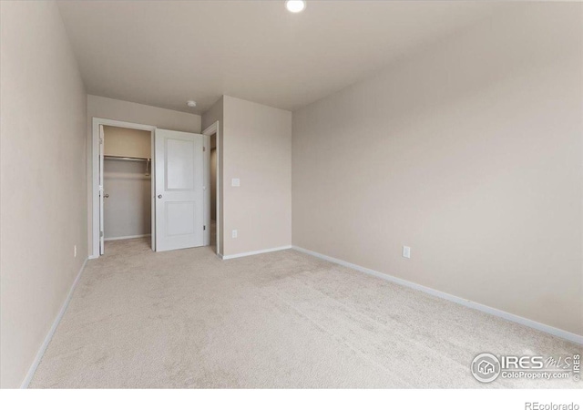 3635 Ronald Reagan Ave, Wellington, CO 80549 - unfurnished bedroom with light carpet, baseboards, and a spacious closet