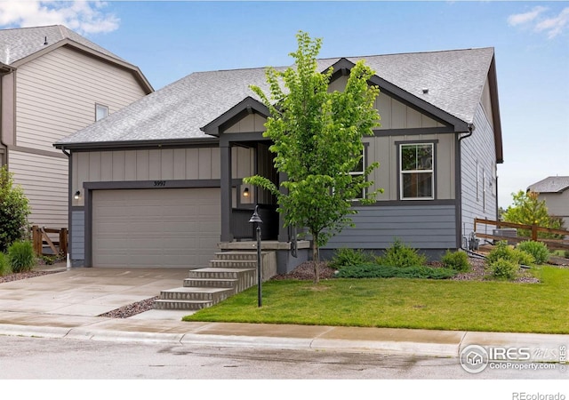 3997 Forest Lake Ct, Loveland, CO 80538 - view of front of property with a garage, driveway, a shingled roof, a front yard, and board and batten siding