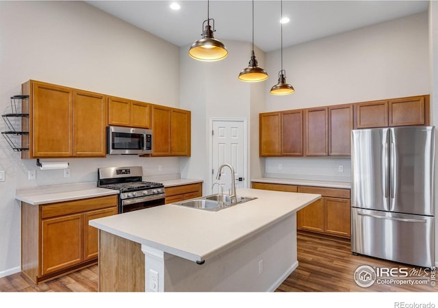 3997 Forest Lake Ct, Loveland, CO 80538 - kitchen featuring stainless steel appliances, a sink, a high ceiling, dark wood-style floors, and light countertops
