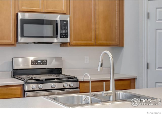 3997 Forest Lake Ct, Loveland, CO 80538 - kitchen featuring stainless steel appliances, light countertops, and a sink