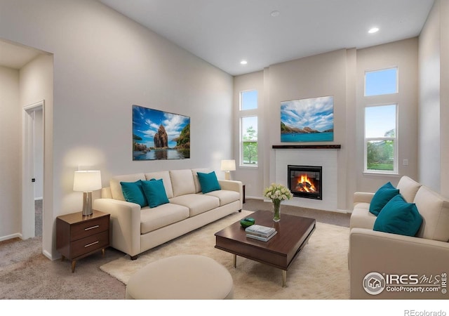 3997 Forest Lake Ct, Loveland, CO 80538 - carpeted living room with a glass covered fireplace, baseboards, and recessed lighting