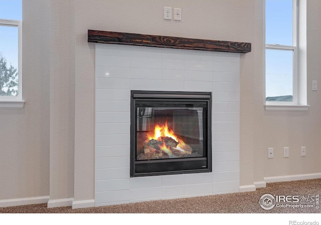 3997 Forest Lake Ct, Loveland, CO 80538 - detailed view of carpet, a glass covered fireplace, and baseboards