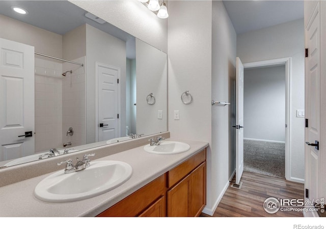3997 Forest Lake Ct, Loveland, CO 80538 - full bath with wood finished floors, double vanity, shower / tub combination, recessed lighting, and baseboards