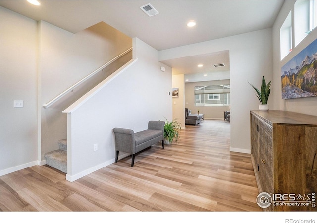 3960 Sweetgum St, Wellington, CO 80549 - corridor with stairs, light wood-type flooring, healthy amount of natural light, recessed lighting, and baseboards