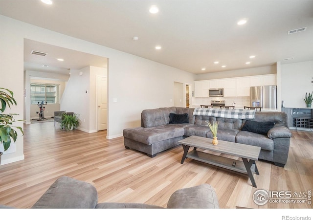 3960 Sweetgum St, Wellington, CO 80549 - living area featuring light wood-style flooring, recessed lighting, and baseboards