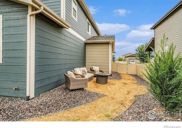 3960 Sweetgum St, Wellington, CO 80549 - fenced backyard featuring an outdoor living space, a patio area, and a gate