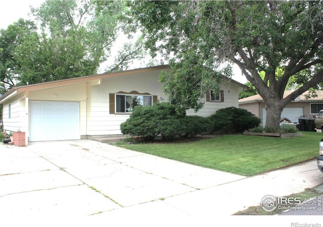 133 Dexter Pl, Fort Morgan, CO 80701 - view of front of property with a garage, concrete driveway, and a front lawn