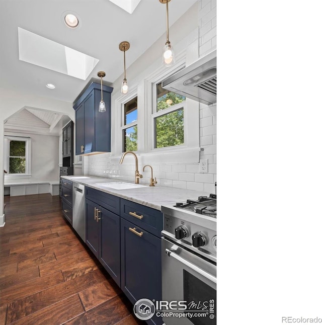 1010 Euclid Ave, Boulder, CO 80302 - kitchen featuring a skylight, blue cabinetry, stainless steel appliances, dark wood-style flooring, and tasteful backsplash