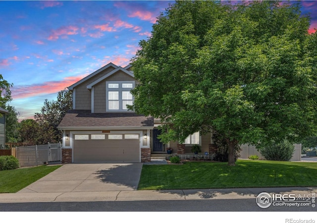 10400 Foxfire St, Firestone, CO 80504 - view of front facade featuring driveway, a garage, and brick siding