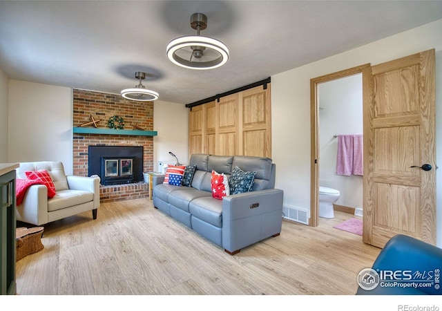 10940 Utica Ct, Westminster, CO 80031 - living area with light wood-style floors and a brick fireplace
