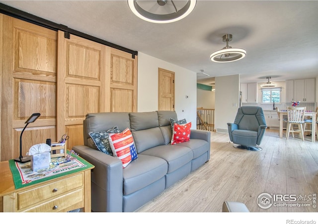 10940 Utica Ct, Westminster, CO 80031 - living room featuring wood finished floors and a barn door