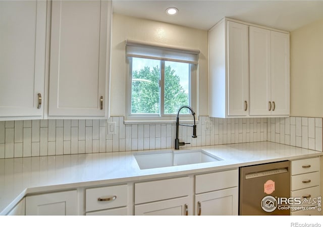 10940 Utica Ct, Westminster, CO 80031 - kitchen featuring stainless steel dishwasher, a sink, decorative backsplash, white cabinetry, and recessed lighting