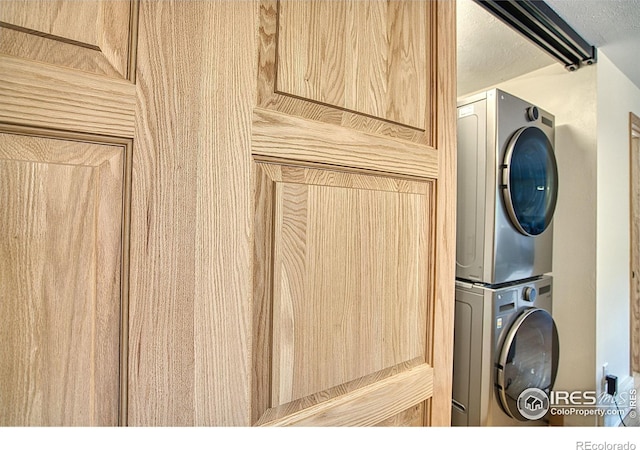 10940 Utica Ct, Westminster, CO 80031 - washroom featuring stacked washer / dryer