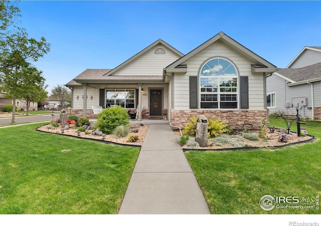 1421 Snipe Ln, Fort Collins, CO 80524 - single story home with a front yard, stone siding, covered porch, and a shingled roof