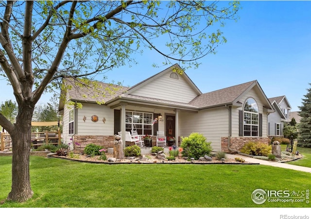 1421 Snipe Ln, Fort Collins, CO 80524 - view of front of house with stone siding, a porch, and a front yard