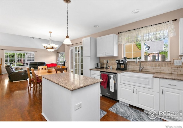 1421 Snipe Ln, Fort Collins, CO 80524 - kitchen featuring stainless steel dishwasher, a sink, dark wood-style flooring, a kitchen island, and backsplash