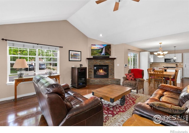 1421 Snipe Ln, Fort Collins, CO 80524 - living area with dark wood-style floors, a fireplace, vaulted ceiling, ceiling fan, and a chandelier