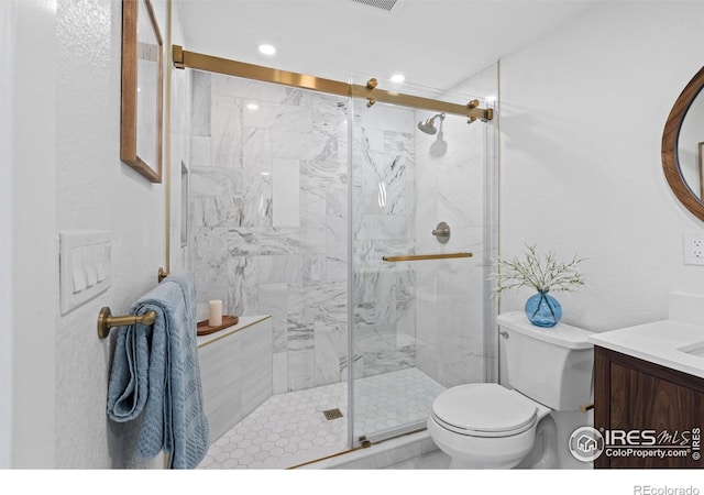 6766 Zenobia Loop, Westminster, CO 80030 - full bathroom featuring toilet, vanity, a marble finish shower, and recessed lighting