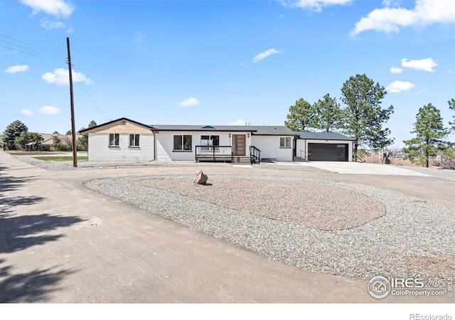 6766 Zenobia Loop, Westminster, CO 80030 - view of front of property featuring concrete driveway, a garage, and covered porch