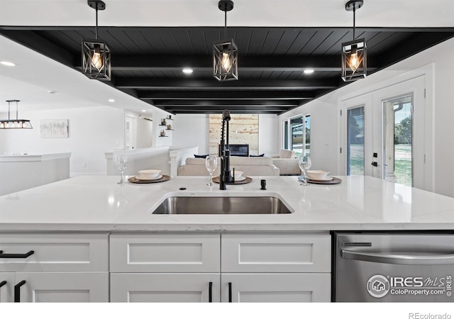 6766 Zenobia Loop, Westminster, CO 80030 - kitchen featuring dishwasher, a sink, white cabinetry, open floor plan, and light stone counters
