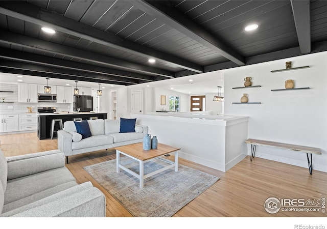 6766 Zenobia Loop, Westminster, CO 80030 - living room with light wood-style floors, recessed lighting, baseboards, and wood ceiling with exposed beams