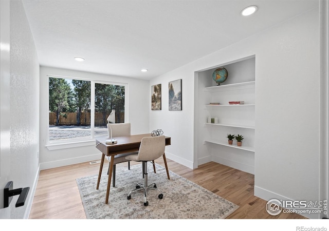 6766 Zenobia Loop, Westminster, CO 80030 - office featuring built in features, baseboards, light wood-style floors, and recessed lighting