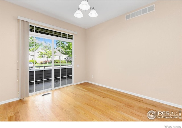 3180 Springfield Dr, Loveland, CO 80538 - unfurnished room with a chandelier, baseboards, and wood finished floors