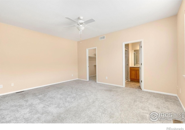 3180 Springfield Dr, Loveland, CO 80538 - unfurnished bedroom with light colored carpet, baseboards, a walk in closet, and connected bathroom