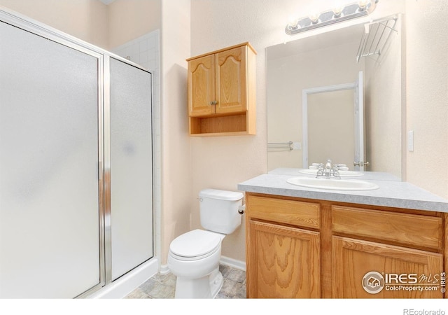 3180 Springfield Dr, Loveland, CO 80538 - full bathroom with toilet, vanity, a shower stall, and tile patterned flooring